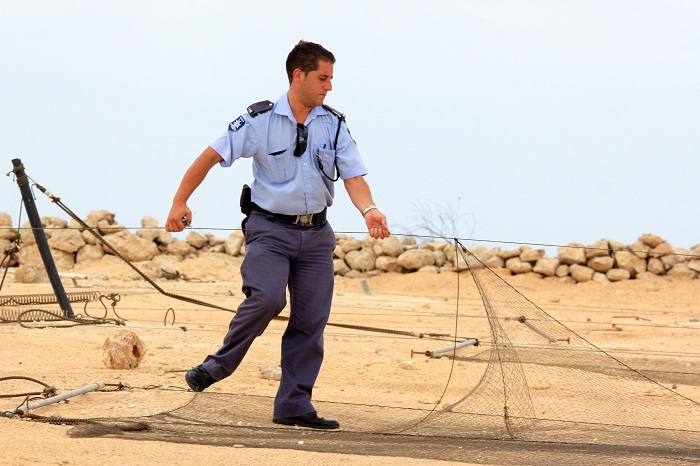 Police dismantling a net for Dunlin